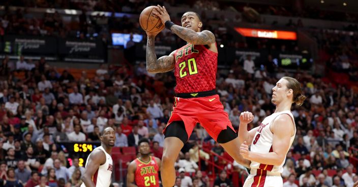 Atlanta Hawks forward John Collins (20) drives to the basket past Miami Heat forward Kelly Olynyk during the first half of an NBA basketball game Tuesday, Oct. 29, 2019, in Miami. (AP Photo/Lynne Sladky)