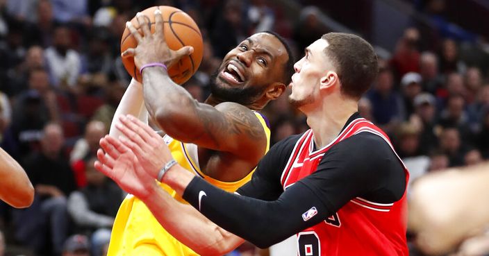 Los Angeles Lakers' LeBron James, left, drives to the basket past Chicago Bulls' Zach LaVine during the first half of an NBA basketball game Tuesday, Nov. 5, 2019, in Chicago. (AP Photo/Charles Rex Arbogast)