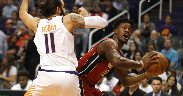 Miami Heat's Jimmy Butler (22) looks to the basket against Phoenix Suns' Ricky Rubio (11) during the first half of an NBA basketball game Thursday, Nov. 7, 2019, in Phoenix. (AP Photo/Darryl Webb)