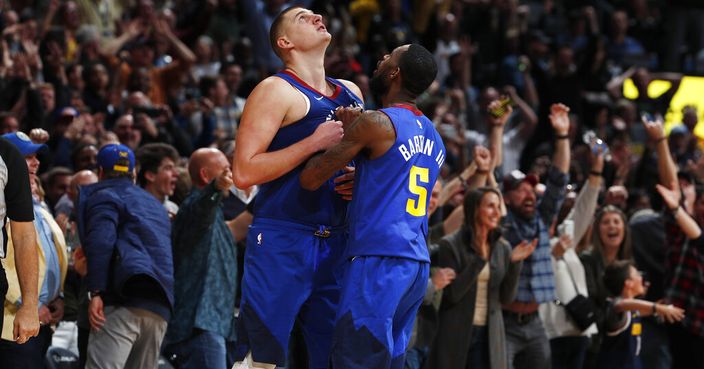 Denver Nuggets center Nikola Jokic, left, is congratulated by guard Will Barton III after hitting the winning basket in the second half of an NBA basketball game against the Philadelphia 76ers, Friday, Nov. 8, 2019, in Denver. (AP Photo/David Zalubowski)