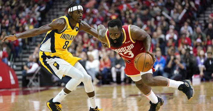 Houston Rockets' James Harden (13) drives toward the basket as Indiana Pacers' Justin Holiday (8) defends during the second half of an NBA basketball game Friday, Nov. 15, 2019, in Houston. The Rockets won 111-102. (AP Photo/David J. Phillip)