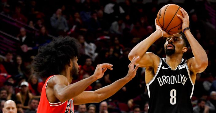 Brooklyn Nets guard Spencer Dinwiddie (8) shoots next to Chicago Bulls guard Coby White during the second half of an NBA basketball game Saturday, Nov. 16, 2019, in Chicago. (AP Photo/Matt Marton)