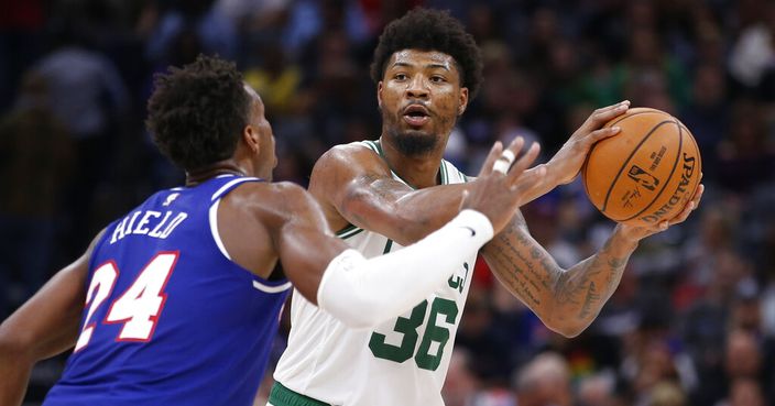 Boston Celtics guard Marcus Smart, right, looks to pass against Sacramento Kings guard Buddy Hield, left, during the second half of an NBA basketball game in Sacramento, Calif., Sunday, Nov. 17, 2019. (AP Photo/Rich Pedroncelli)