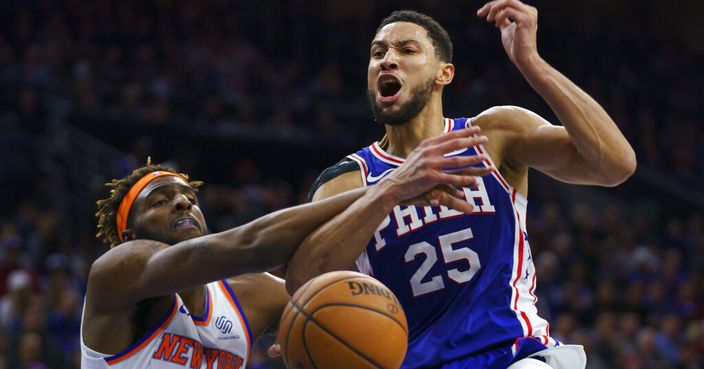 Philadelphia 76ers' Ben Simmons, right, reacts to being fouled by New York Knicks' Mitchell Robinson, left, as he was going up for the shot during the second half of an NBA basketball game, Wednesday, Nov. 20, 2019, in Philadelphia. The 76ers won 109-104. (AP Photo/Chris Szagola)