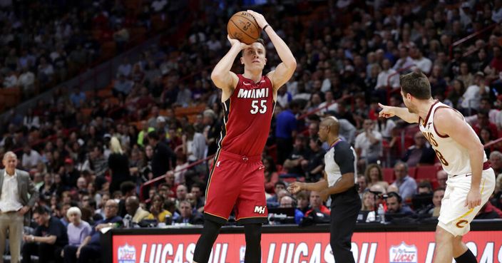 Miami Heat forward Duncan Robinson (55) shoots as Cleveland Cavaliers guard Matthew Dellavedova during the second half of an NBA basketball game, Wednesday, Nov. 20, 2019, in Miami. The Heat won 124-100. (AP Photo/Lynne Sladky)