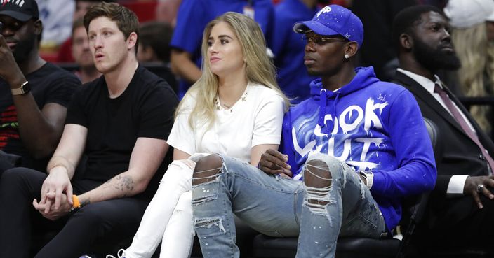 Manchester United soccer player Paul Pogba, right, sits courtside during an NBA basketball game between the Miami Heat and Cleveland Cavaliers, Wednesday, Nov. 20, 2019, in Miami. The Heat won 124-100. (AP Photo/Lynne Sladky)