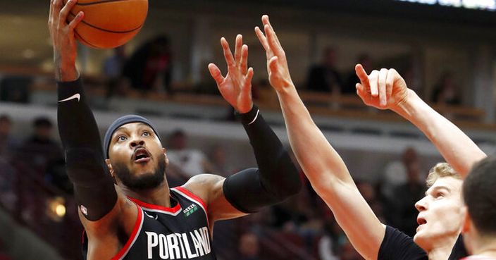 Portland Trail Blazers' Carmelo Anthony scores past Chicago Bulls' Lauri Markkanen during the first half of an NBA basketball game Monday, Nov. 25, 2019, in Chicago. (AP Photo/Charles Rex Arbogast)