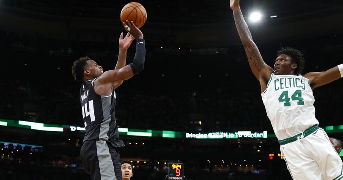 Sacramento Kings' Buddy Hield, left, shoots against Boston Celtics' Robert Williams III during the fourth quarter of an NBA basketball game Monday, Nov. 25, 2019, in Boston. (AP Photo/Winslow Townson)