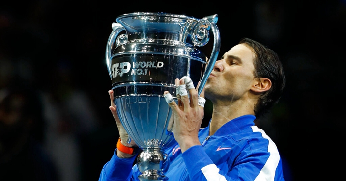 Spain's Rafael Nadal lifts the ATP World Number 1 trophy following the presentation on court after his match against Stefanos Tsitsipas of Greece at the ATP World Tours Finals in the O2 Arena in London, Friday, Nov. 15, 2019. (AP Photo/Alastair Grant)