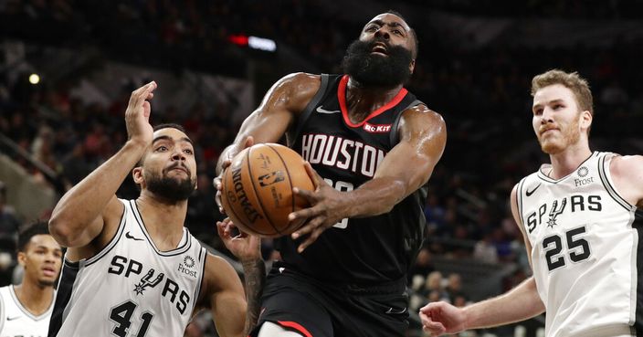 Houston Rockets guard James Harden (13) drives past San Antonio Spurs forward Trey Lyles (41) and center Jakob Poeltl (25) during the first half of an NBA basketball game in San Antonio, Tuesday, Dec. 3, 2019. (AP Photo/Eric Gay)