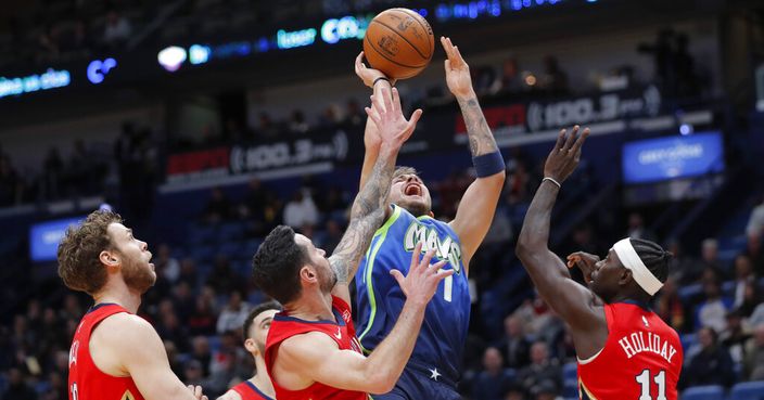 Dallas Mavericks forward Luka Doncic (77) shoots between New Orleans Pelicans forward Nicolo Melli, left, guard JJ Redick and guard Jrue Holiday (11) in the first half of an NBA basketball game in New Orleans, Tuesday, Dec. 3, 2019. (AP Photo/Gerald Herbert)