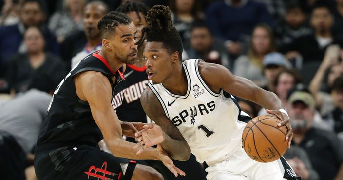 San Antonio Spurs guard Lonnie Walker IV (1) drives around Houston Rockets forward Thabo Sefolosha during the first half of an NBA basketball game in San Antonio, Tuesday, Dec. 3, 2019. (AP Photo/Eric Gay)