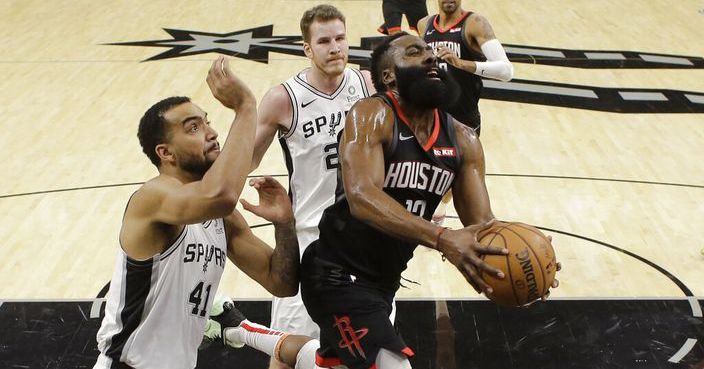 Houston Rockets guard James Harden (13) drives past San Antonio Spurs forward Trey Lyles (41) and center Jakob Poeltl (25) during the first half of an NBA basketball game in San Antonio, Tuesday, Dec. 3, 2019. (AP Photo/Eric Gay)