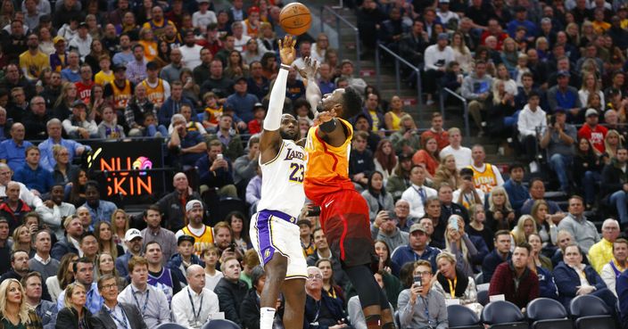 Los Angeles Lakers forward LeBron James (23) shoots as Utah Jazz forward Jeff Green defends during the first half of an NBA basketball game Wednesday, Dec. 4, 2019, in Salt Lake City. (AP Photo/Rick Bowmer)