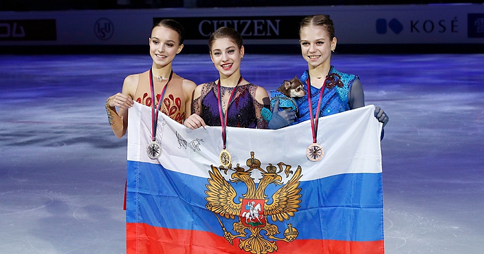 Russia's Alena Kostornaia, center, winner of the women's free skating program, celebrates on the podium with second placed Russia's Anna Shcherbakova, left, and third placed Russia's Alexandra Trusova during the figure skating Grand Prix finals at the Palavela ice arena, in Turin, Italy, Saturday, Dec. 7, 2019. (AP Photo/Antonio Calanni)