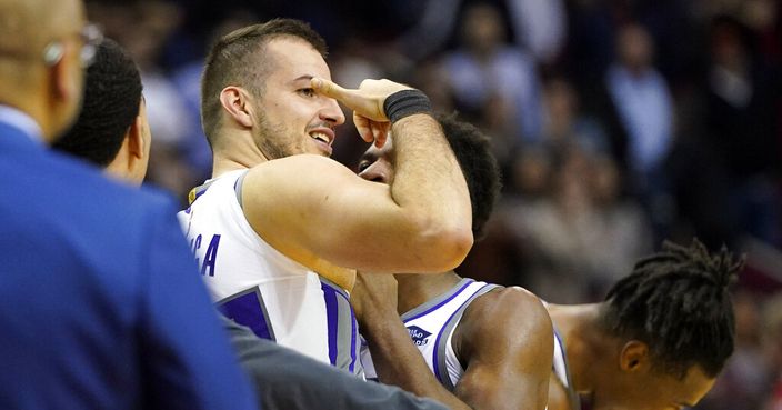 Sacramento Kings' Nemanja Bjelica, center left, celebrates with teammates after making a game-winning 3-point-basket at the end of the second half of an NBA basketball game against the Houston Rockets Monday, Dec. 9, 2019, in Houston. The Kings won 119-118. (AP Photo/David J. Phillip)