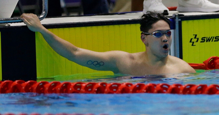 Singapore's Joseph Schooling celebrates after winning in the men's 4x100m freestyle final during swimming competition at the 30th Southeast Asian Games in New Clark City, Tarlac province, northern Philippines on Friday, Dec. 6, 2019. (AP Photo/Tatan Syuflana)