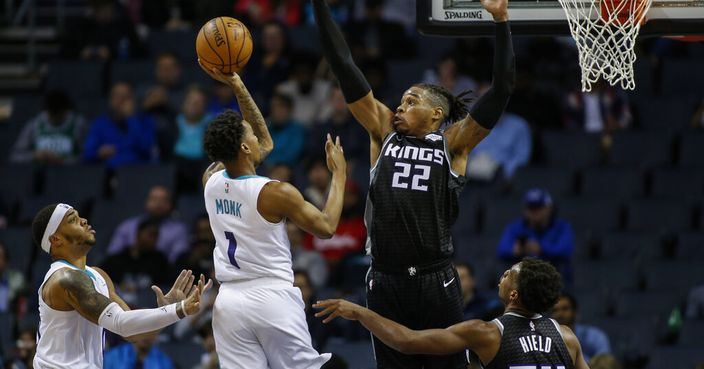 Charlotte Hornets guard Malik Monk (1) shoots against Sacramento Kings forward Richaun Holmes (22) in the second half of an NBA basketball game in Charlotte, N.C., Tuesday, Dec. 17, 2019. Monk scored 23 points as Charlotte defeated Sacramento 110-102. (AP Photo/Nell Redmond)