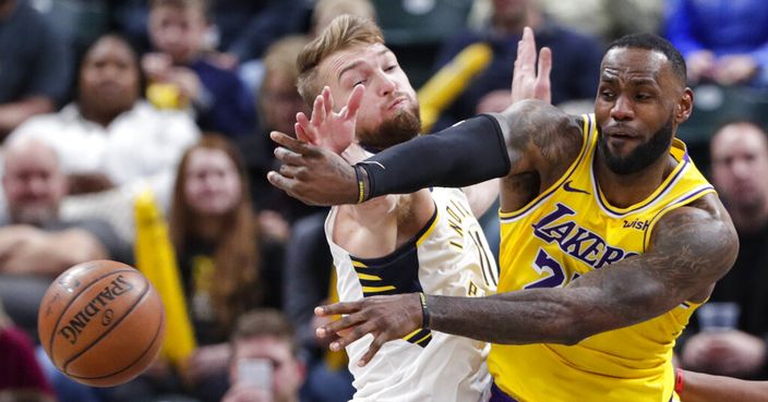 Los Angeles Lakers forward LeBron James (23) makes a pass in front of Indiana Pacers forward Domantas Sabonis (11) during the second half of an NBA basketball game in Indianapolis, Tuesday, Dec. 17, 2019. The Pacers defeated the Lakers 105-102. (AP Photo/Michael Conroy)