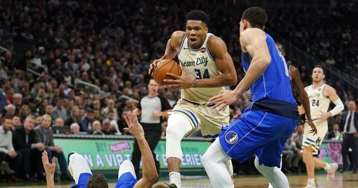 Milwaukee Bucks' Giannis Antetokounmpo drives past Dallas Mavericks' Maxi Kleber and Dwight Powell during the second half of an NBA basketball game Monday, Dec. 16, 2019, in Milwaukee. The Mavericks won 120-116. (AP Photo/Morry Gash)