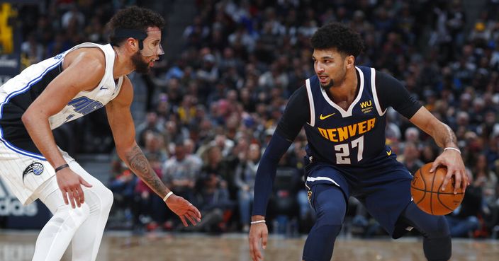 Denver Nuggets guard Jamal Murray, right, looks to drive to the net past Orlando Magic guard Michael Carter-Williams in the second half of an NBA basketball game Wednesday, Dec. 18, 2019, in Denver. The Nuggets won 113-104. (AP Photo/David Zalubowski)