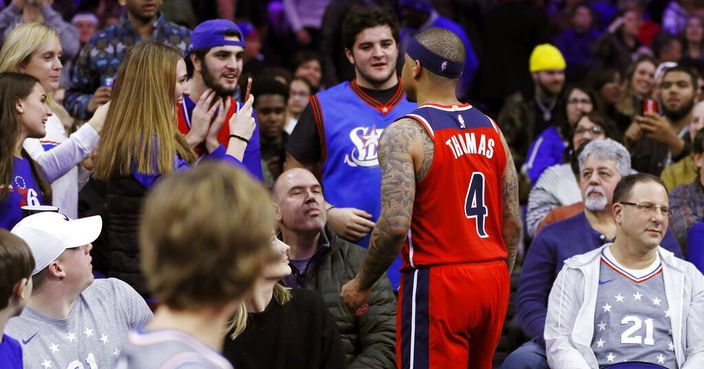 Washington Wizards' Isaiah Thomas talks with fans in the stands during the second half of an NBA basketball game against the Philadelphia 76ers, Saturday, Dec. 21, 2019, in Philadelphia. Thomas was ejected from the game after leaving the court. (AP Photo/Matt Slocum)