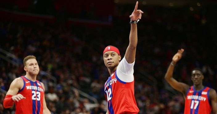 Detroit Pistons guard Tim Frazier (12) points to the crowd as he celebrates with forward Blake Griffin (23) and guard Tony Snell (17) late in the fourth quarter of an NBA basketball game against the Washington Wizards, Thursday, Dec. 26, 2019, in Detroit. (AP Photo/Duane Burleson)