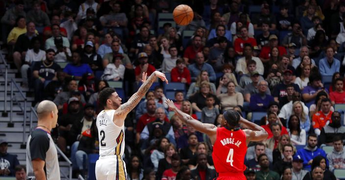 New Orleans Pelicans guard Lonzo Ball (2) shoots a three-point basket against Houston Rockets forward Danuel House Jr. (4) in the first half of an NBA basketball game in New Orleans, Sunday, Dec. 29, 2019. (AP Photo/Gerald Herbert)