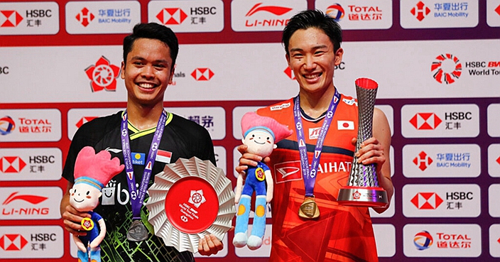 Winner Kento Momota of Japan, right, and runner-up Anthony Sinisuka pose with their trophies after their men's singles badminton final match at the World Tour Finals in Guangzhou in south China's Guangdong province, Sunday, Dec. 15, 2019. (AP Photo/Andy Wong)