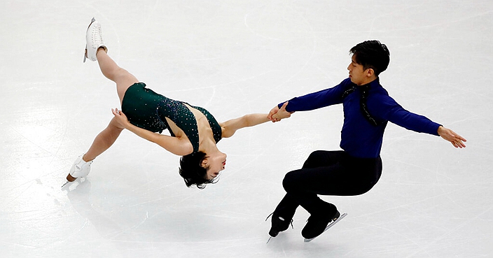 China's Wenjing Sui and Cong Han compete in the pairs free skating during the figure skating Grand Prix finals at the Palavela ice arena, in Turin, Italy, Friday, Dec. 6, 2019. (AP Photo/Antonio Calanni)