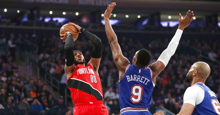 New York Knicks guard RJ Barrett (9) defends as Portland Trail Blazers forward Carmelo Anthony (00) shoots during the first half of an NBA basketball game in New York, Wednesday, Jan. 1, 2020. (AP Photo/Kathy Willens)