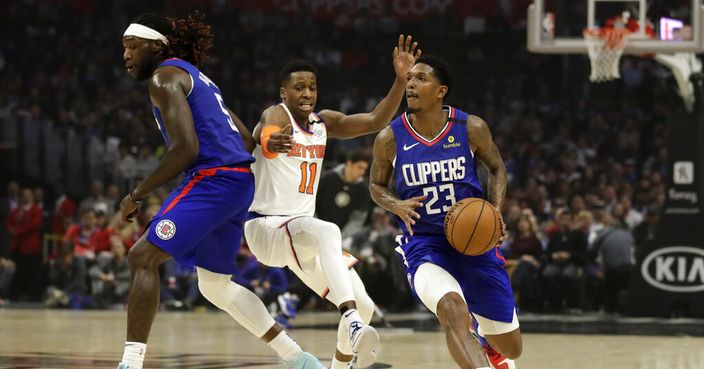 Los Angeles Clippers' Lou Williams, right, dribbles around a screen set by teammate Montrezl Harrell, left, on New York Knicks' Frank Ntilikina (11) during the first half of an NBA basketball game Sunday, Jan. 5, 2020, in Los Angeles. (AP Photo/Marcio Jose Sanchez)
