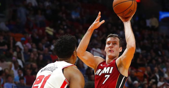 Miami Heat guard Goran Dragic (7) goes up for a shot against Portland Trail Blazers center Hassan Whiteside (21) during the second half of an NBA basketball game, Sunday, Jan. 5, 2020, in Miami. Dragic had 29 points and 13 assists as the Heat defeated the Trail Blazers 122-111. (AP Photo/Wilfredo Lee)