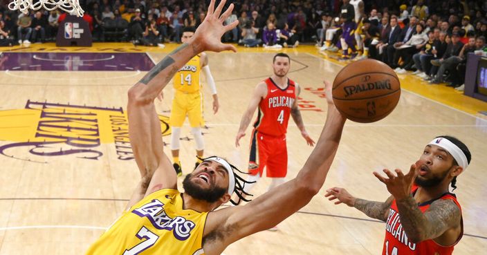Los Angeles Lakers center JaVale McGee, left, reaches for a rebound next to New Orleans Pelicans forward Brandon Ingram during the second half of an NBA basketball game Friday, Jan. 3, 2020, in Los Angeles. The Lakers won 123-113. (AP Photo/Mark J. Terrill)