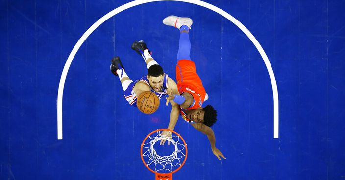 Philadelphia 76ers' Ben Simmons, left, goes up for a shot against Oklahoma City Thunder's Shai Gilgeous-Alexander during the first half of an NBA basketball game, Monday, Jan. 6, 2020, in Philadelphia. (AP Photo/Matt Slocum)