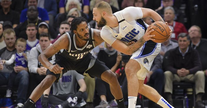 Sacramento Kings forward Trevor Ariza (0) defends against Orlando Magic guard Evan Fournier (10) during the second half of an NBA basketball game in Sacramento, Calif., Monday, Jan. 13, 2020. The Orlando Magic won 114-112. (AP Photo/Randall Benton)