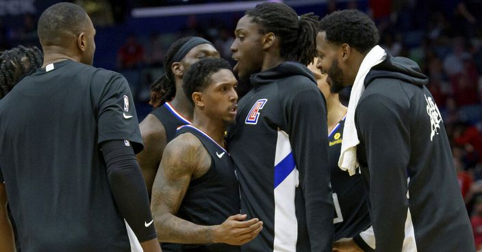 Los Angeles Clippers guard Lou Williams (23), center left, is surrounded by teammates after Williams scored a three point basket to give the Clippers the lead over New Orleans Pelicans in the second half an NBA basketball game in New Orleans, Saturday, Jan. 18, 2020. (AP Photo/Matthew Hinton)