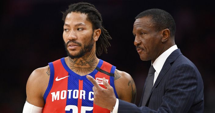 Detroit Pistons head coach Dwane Casey, right, talks with guard Derrick Rose (25) during the first half of an NBA basketball game against the Washington Wizards, Monday, Jan. 20, 2020, in Washington. (AP Photo/Nick Wass)