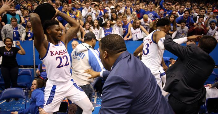 LAWRENCE, KANSAS - JANUARY 21:  Silvio De Sousa #22 of the Kansas Jayhawks picks up a chair during a brawl as the game against the Kansas State Wildcats ends at Allen Fieldhouse on January 21, 2020 in Lawrence, Kansas. (Photo by Jamie Squire/Getty Images)