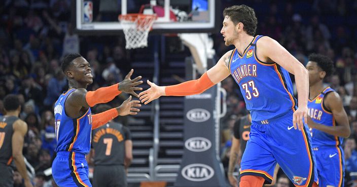 Oklahoma City Thunder guard Dennis Schroder (17) and forward Mike Muscala (33) celebrate after scoring a basket during the second half of an NBA basketball game against the Orlando Magic Wednesday, Jan. 22, 2020, in Orlando, Fla. (AP Photo/Phelan M. Ebenhack)