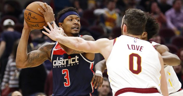 Washington Wizards' Bradley Beal (3) looks to pass against Cleveland Cavaliers' Kevin Love (0) in the second half of an NBA basketball game, Thursday, Jan. 23, 2020, in Cleveland. Washington won 124-112. (AP Photo/Tony Dejak)