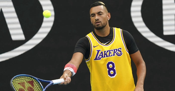 Australia's Nick Kyrgios wears a shirt as a tribute to Kobe Bryant as he warms-up for his fourth round singles match against Spain's Rafael Nadal at the Australian Open tennis championship in Melbourne, Australia, Monday, Jan. 27, 2020. (AP Photo/Lee Jin-man)