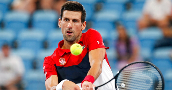 Novak Djokovic of Serbia plays a shot against Daniil Medvedev of Russia during their ATP Cup tennis semifinal match in Sydney, Saturday, Jan. 11, 2020. (AP Photo/Steve Christo)