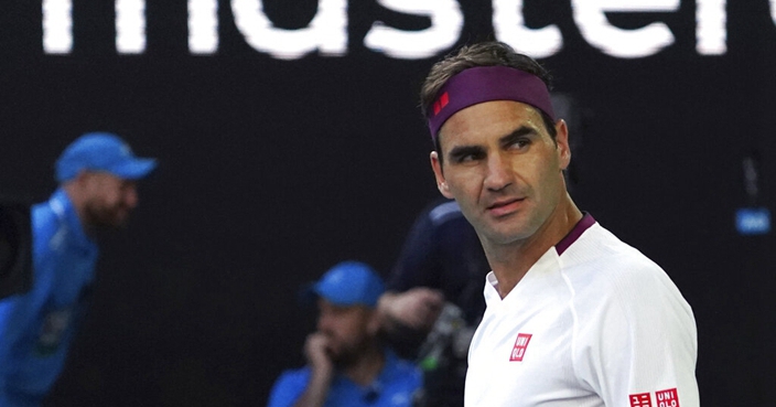 Switzerland's Roger Federer reacts after defeating Tennys Sandgren of the U.S. in their quarterfinal match at the Australian Open tennis championship in Melbourne, Australia, Tuesday, Jan. 28, 2020. (AP Photo/Lee Jin-man)