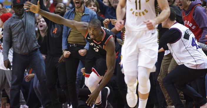 Fans react after Toronto Raptors center Serge Ibaka (9) scores the game winning three point basket to defeat the Indiana Pacers during the second half of an NBA basketball game, Wednesday, Feb. 5, 2020 in Toronto. (Nathan Denette/The Canadian Press via AP)