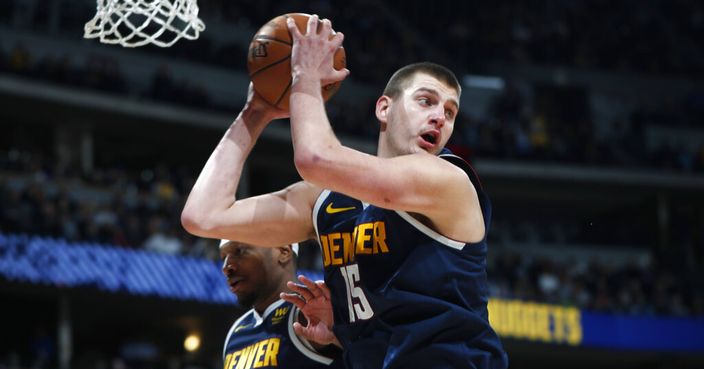 Denver Nuggets center Nikola Jokic, front, pulls in a rebound in front of forward Torrey Craig in the second half of an NBA basketball game against the San Antonio Spurs Monday, Feb.10, 2020, in Denver. The Nuggets won 127-120. (AP Photo/David Zalubowski)