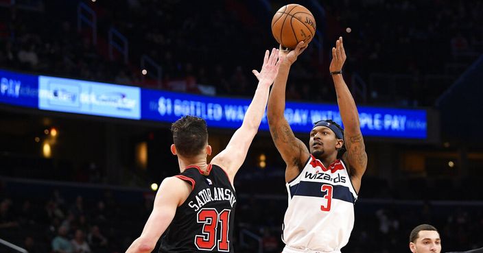 Washington Wizards guard Bradley Beal (3) shoots as he is defended by Tomas Satoransky during the second half of an NBA basketball game, Tuesday, Feb. 11, 2020, in Washington. The Wizards won 126-114. (AP Photo/Nick Wass)