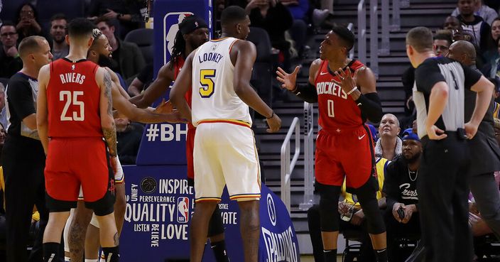 Houston Rockets' Russell Westbrook (0) gestures while speaking to Golden State Warriors' Kevon Looney (5) in the fourth quarter of an NBA basketball game Thursday, Feb. 20, 2020, in San Francisco. Westbrook was ejected after receiving a second technical foul in the fourth quarter. (AP Photo/Ben Margot)