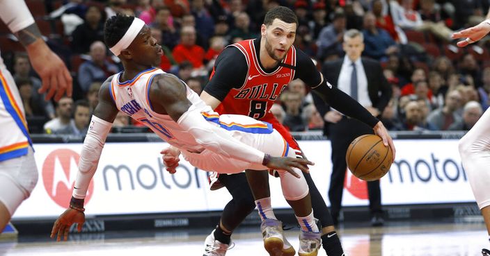 Oklahoma City Thunder's Dennis Schroeder, left, draws a charge from Chicago Bulls' Zach LaVine during the second half of an NBA basketball game Tuesday, Feb. 25, 2020, in Chicago. The Thunder won 124-122. (AP Photo/Charles Rex Arbogast)