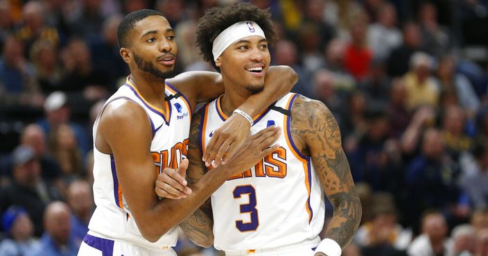Phoenix Suns forward Mikal Bridges, left, and forward Kelly Oubre Jr. (3) react to a foul called on Oubre in the first half during an NBA basketball game against the Utah Jazz, Monday, Feb. 24, 2020, in Salt Lake City. (AP Photo/Rick Bowmer)